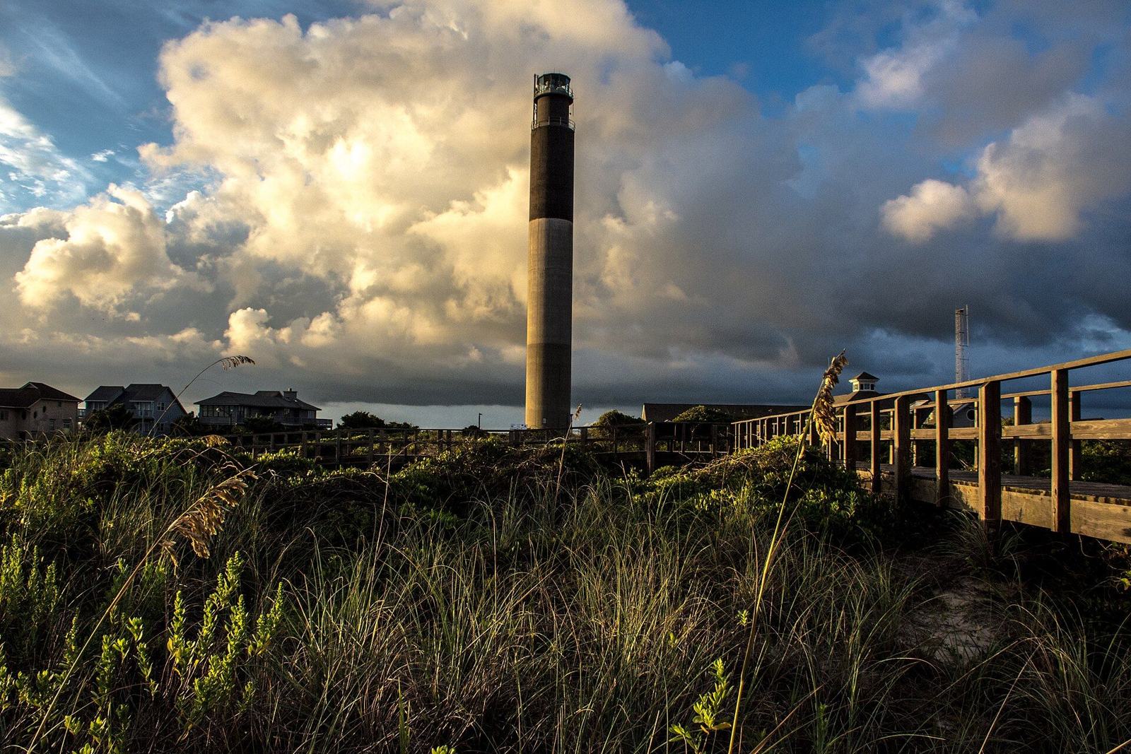 Wooden walkway through dune grass beside the Oak Island Lighthouse