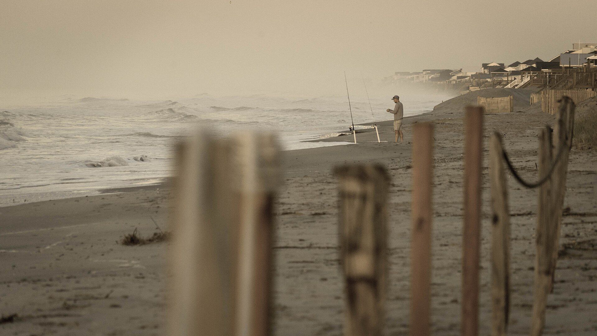 Surf fisherman casting from the beach at Oak Island